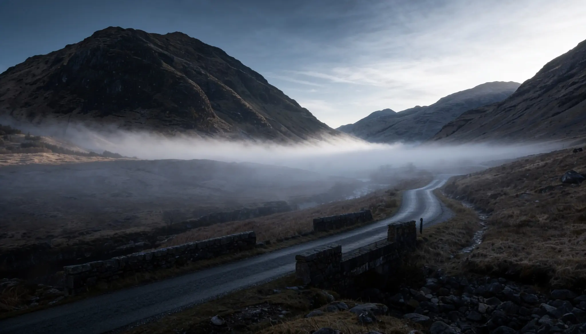Remote road through the misty Scottish Highlands, recalling the landscape and atmosphere of Skyfall